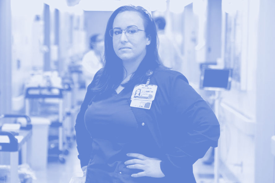 Stephanie Lichtwardt standing, hands on hips, in a hallway of U C San Diego Medical Center